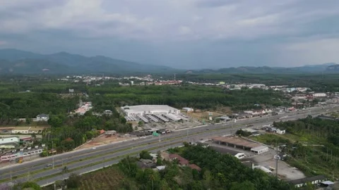 Drone timelapse  - over a road and building , clouds moving fast Stock Footage 192570215