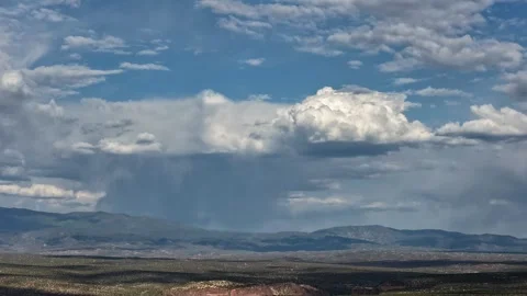 Drone Timelapse of Rain and Morphing Clouds Over a Desert Mountain Stock Footage 336526781