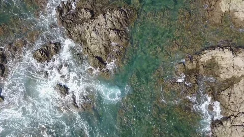 Drone top down aerial of rocks and waves Playa Prieta Stock Footage 91106364
