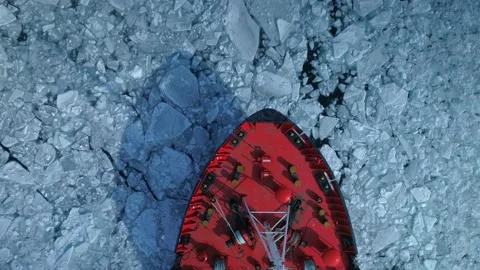 Drone top down Epic red steel icebreaker ship tanker breaks winter frozen sea 4k Video stock 136226137