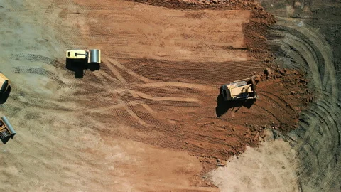 Drone top down footage. A many bulldozer levels a plot of land for development Stock Footage 224532501
