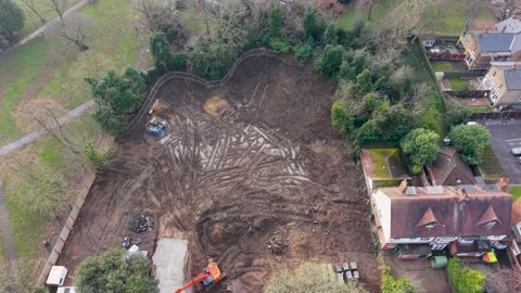 Drone top-down over cleared property plot, Wanstead, with digger and trees Stock Footage 327788972