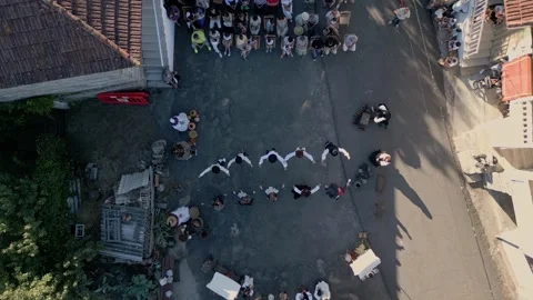Drone top down perspective of line dance performed at ethnographic Stock Footage 248209507