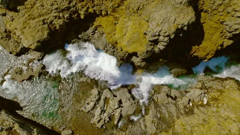 Drone Top Down Shot of Narrow Waterfalls Surrounded by Vast Rocky Mountain Land Stock Footage 157374274