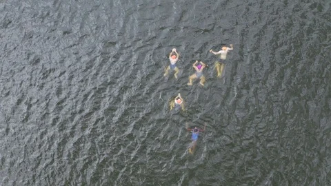 Drone top down shot of swimmers in lake outdoors Stock Footage 128020088