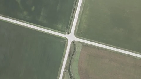 Drone Top-Down Spin CCW Over Rural Intersection in Iowa Farmland – 4K Video stock 315991171
