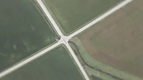 Drone Top-Down Spin CW Over Rural Intersection in Iowa Farmland – 4K Video stock 315992844
