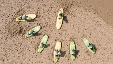 Drone top down of surf lesson on the beach, learning the basics Stock Footage 143243610