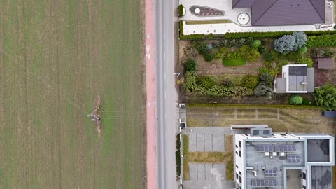 Drone Top Down Tracking Truck Driving Between Residential Houses And Field Stock Footage 330750764