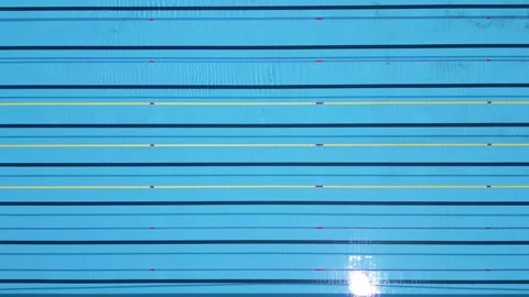 Drone top-down view of an empty Olympic-size swimming pool with lane dividers Stock Footage 310797743