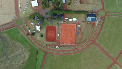 Drone top-down view of equestrian sports training facility with red dirt arenas Stock Footage 306952488