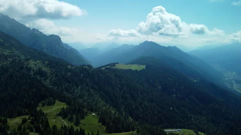 Drone top-down view of flat mountain top, green valley, forest, and rocks Stock Footage 314191427