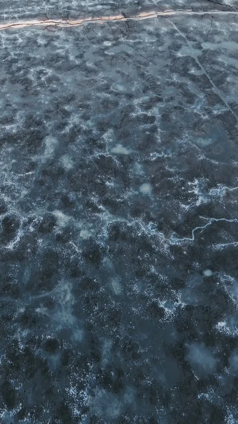 Drone top down view of frozen pond in Barycz Valley, winter abstract texture Stock Footage 334759133