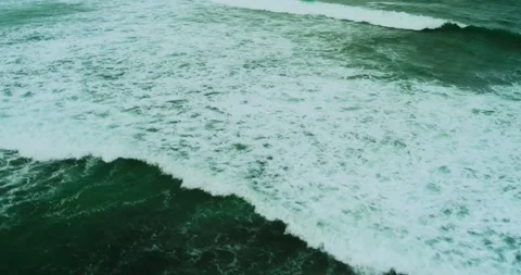 Drone Top Down View of Turquoise Waves Rolling Over Shoreline Stock Footage 330586363