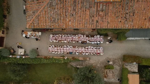 Drone Top-Down View of Wedding Guests at Long Dinner Tables in Italy Stock Footage 308645787