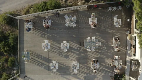 Drone top shot of a cafe with many tables, people having dinner. Stock Footage 202039468