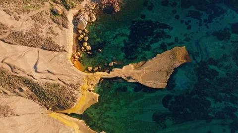 Drone top sunset view of sand beach and people. Ghain Tuffieha, Maltese island Stock Footage 323571344