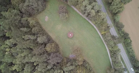 Drone top view of an light in the woods with street nearby 動画素材 79602842