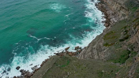 Drone top view  over rolling ocean waves to the rocky shore. Stock Footage 198428076