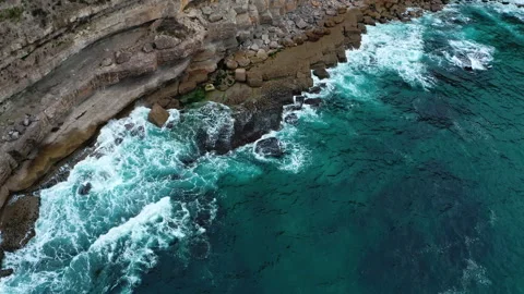 Drone top view  over rolling ocean waves to the rocky shore. Drone  flies o.. Stock Footage 254623107