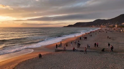 Drone top view: a sandy beach with parasol next to a restaurant terrace, shore Stock Footage 236724476