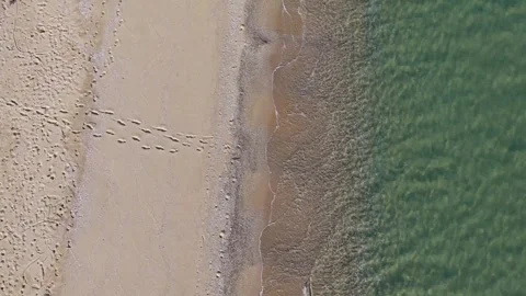 Drone top view of sandy beach coastline with waves and textures Stock Footage 321966614