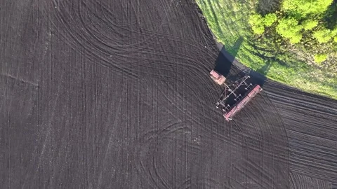Drone top view of sowing machine working across agricultural field with soi.. Stock Footage 337445065