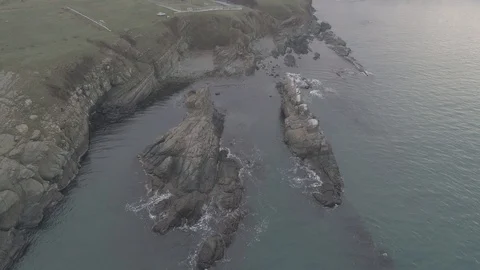 Drone top view Sunset the beach coast with rocks in foreground-not editing-4k Видео 100129178