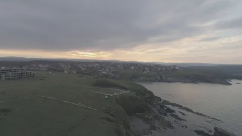 Drone top view Sunset the beach coast with rocks in foreground-not editing-4k Vidéo 100129184