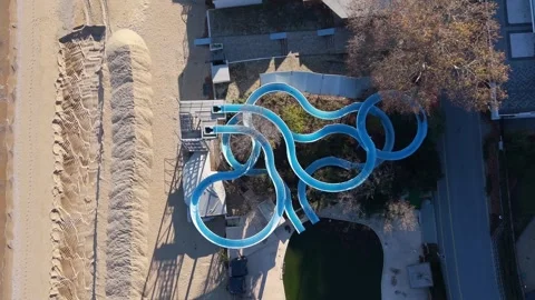 Drone top view of winding blue water slides in empty park Stock Footage 321966602