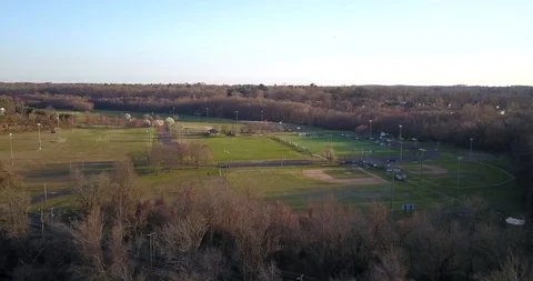 Drone towards small park with baseball diamond and soccer field Vídeos de archivo 127053630
