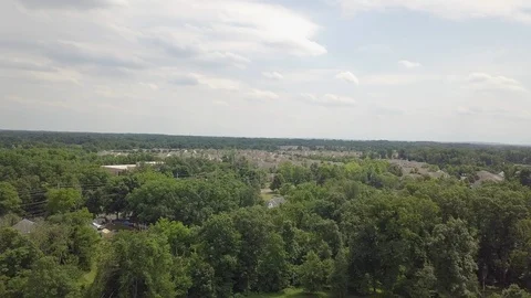 Drone Town from far over trees 스톡 동영상 90924862