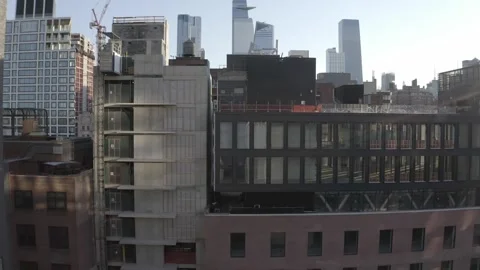 Drone track and rotate around distinct glass facade High Line building in NYC  库存影片 248536722