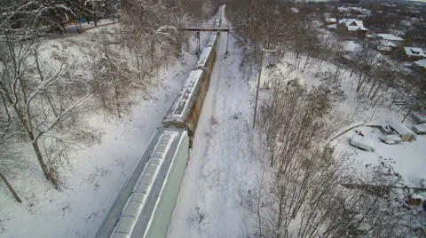 Drone: Track Forward over a Freight Train in the Snow Stock Footage 61856953