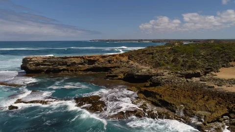 Drone tracking along the rocky coastline at Peterborough Stock Footage 87708129