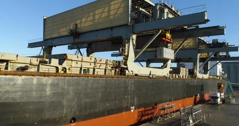 Drone tracking up and over ship loading aluminum ingots for export. Stock Footage 87855490