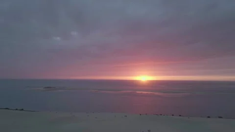 Drone tracking backward from very distant Dune du Pilat with sunset, France Видео 333108342