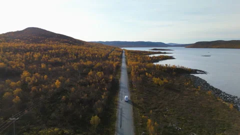 Drone tracking a camper van driving in arctic, autumn wilderness of Finland Stock Footage 299613334