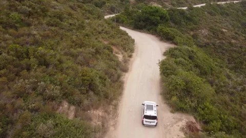 Drone tracking camper van with solar panel along dirt road, Elba, Italy Видео 336331350