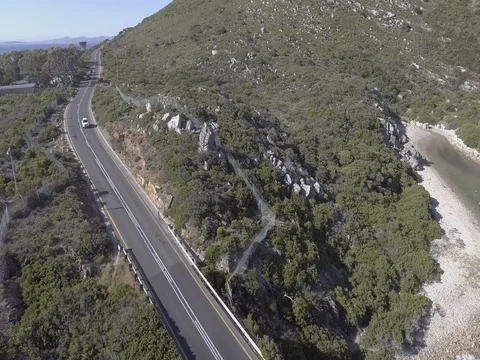 Drone tracking car driving across bridge over river on Coastal Road, Cape Town Video stock 80724847