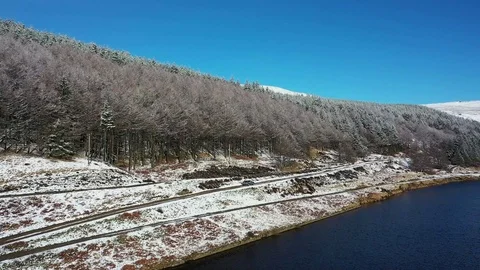 Drone Tracking Car in Winter Setting - Saddleworth Stock Footage 104818886