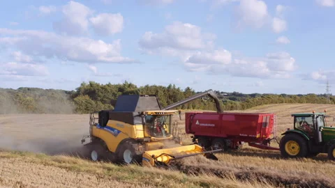 Drone Tracking Combine And Tractor Harvesting Crops Stock Footage 139893829