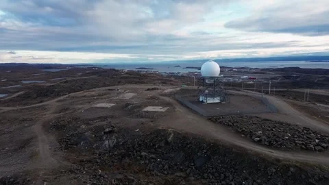 Drone Tracking Flight Over Tundra Bedrock Toward Hilltop Radar Station Stock Footage 346602611