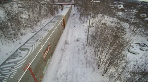 Drone: Tracking Forward over the end of the Freight Train in the Snow Stock Footage 61855645