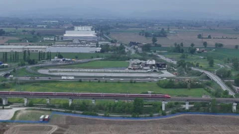 Drone tracking Frecciarossa high speed train passing viaduct near A1 and A21 in Stock Footage 335185971