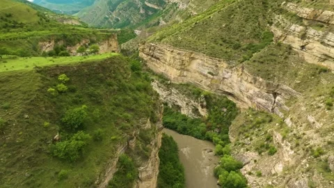 Drone tracking the Kara-Koisu River, Dagestan, as it snakes through the verdant Stock Footage 303417493