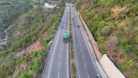 Drone tracking Loaded commercial freight truck on scenic mountain road.  Stockbeeldmateriaal 335639362