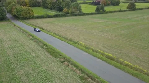 Drone tracking a moving car 스톡 동영상 147514817