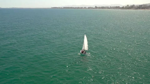 Drone tracking over the blue sea passing sailing boat Stock-Footage 150405951