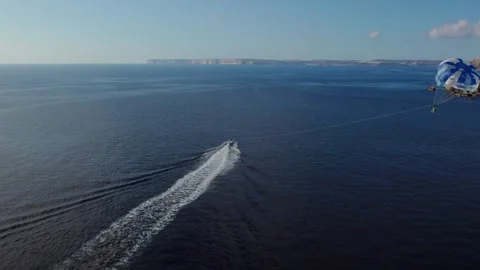 Drone Tracking Parasailing Over Golden Bay in Malta Vídeo Stock 320148601
